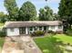 Charming home with a well-manicured lawn, colorful flower beds, and a concrete driveway leading to the entrance at 3844 Sw Saddle Ridge Dr, Snellville, GA 30039