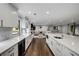 Bright kitchen with white cabinets, quartz countertops and open view to the living area at 3844 Sw Saddle Ridge Dr, Snellville, GA 30039