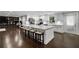 Spacious open kitchen with white cabinetry, a large island, and dark wood floors at 3844 Sw Saddle Ridge Dr, Snellville, GA 30039