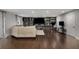 Cozy living room featuring hardwood floors, comfortable seating, and custom shelving at 3844 Sw Saddle Ridge Dr, Snellville, GA 30039