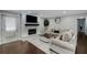 Bright living room with a fireplace, comfortable seating, and dark wood flooring at 3844 Sw Saddle Ridge Dr, Snellville, GA 30039