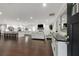 Open-concept living space with dark wood flooring, a fireplace, and modern furnishings at 3844 Sw Saddle Ridge Dr, Snellville, GA 30039