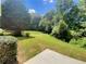 Lush green backyard with mature trees, ample space for outdoor enjoyment at 5159 Round Table Dr, Ellenwood, GA 30294