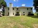 Large backyard featuring a lush lawn, mature trees, and a patio at 5159 Round Table Dr, Ellenwood, GA 30294