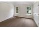 Bedroom featuring neutral carpet, white trim, and ample natural light at 5159 Round Table Dr, Ellenwood, GA 30294