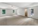 Expansive bonus room featuring neutral walls, carpet floors, multiple windows, and two doors at 5159 Round Table Dr, Ellenwood, GA 30294