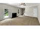 Open-concept living space with a fireplace, access to the backyard, and staircase leading to the upper level at 5159 Round Table Dr, Ellenwood, GA 30294