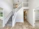Bright foyer featuring a carpeted staircase and tile flooring at 5159 Round Table Dr, Ellenwood, GA 30294