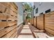 A fenced backyard with a stone paver walkway and garden beds provides a secluded outdoor space at 658 Mcgruder Ne St, Atlanta, GA 30312
