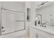 Modern bathroom featuring a white vanity with quartz counters and shower with glass enclosure at 658 Mcgruder Ne St, Atlanta, GA 30312