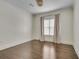 Sunlit bedroom featuring hardwood floors, a window with decorative curtains, and chandelier at 658 Mcgruder Ne St, Atlanta, GA 30312