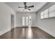 Bright bedroom featuring hardwood floors, ceiling fan, and double doors to balcony at 658 Mcgruder Ne St, Atlanta, GA 30312