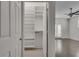 Walk-in closet providing ample storage with custom shelving, clothing rack, and plush carpet at 658 Mcgruder Ne St, Atlanta, GA 30312