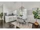 Bright dining area with modern chandelier, dark table, and stylish decor in an open floor plan at 658 Mcgruder Ne St, Atlanta, GA 30312