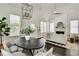 Open dining area with pendant lighting, sleek table, and seamless flow to the bright living room at 658 Mcgruder Ne St, Atlanta, GA 30312