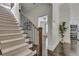 Inviting entryway with hardwood floors, staircase, and view of a modern kitchen at 658 Mcgruder Ne St, Atlanta, GA 30312
