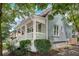 Side view of a light blue house with a white porch and green landscaping at 658 Mcgruder Ne St, Atlanta, GA 30312