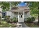 Charming home with a covered front porch, white railings, and well-manicured landscaping at 658 Mcgruder Ne St, Atlanta, GA 30312