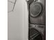 Laundry area featuring stacked washer and dryer with wire shelving at 658 Mcgruder Ne St, Atlanta, GA 30312