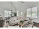 Bright living room with vaulted ceilings, large windows, and cozy, neutral-toned furniture at 658 Mcgruder Ne St, Atlanta, GA 30312