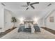 Bright main bedroom showcasing vaulted ceilings, a ceiling fan, and hardwood floors topped with a large area rug at 658 Mcgruder Ne St, Atlanta, GA 30312