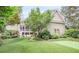 Beautiful backyard with an artificial grass lawn, lush landscaping, putting green, and a screened-in porch at 15 Northwood Ne Ave, Atlanta, GA 30309