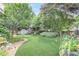 Large backyard features a lush lawn, mature trees, and tasteful landscaping at 15 Northwood Ne Ave, Atlanta, GA 30309
