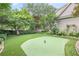 Lush backyard featuring a putting green and an inviting hammock for relaxation among mature trees at 15 Northwood Ne Ave, Atlanta, GA 30309