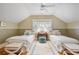 Charming bedroom features twin beds, a soft rug, and soothing natural light filtering through the window at 15 Northwood Ne Ave, Atlanta, GA 30309