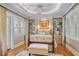 Serene bedroom features a four-poster bed, tray ceiling, and bright windows for a peaceful retreat at 15 Northwood Ne Ave, Atlanta, GA 30309
