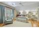 Comfortable bedroom boasts a patterned chair, soft rug, and soothing natural light filtering through the window at 15 Northwood Ne Ave, Atlanta, GA 30309