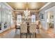 Formal dining room with chandelier, wainscoting, large windows, and neutral color palette at 15 Northwood Ne Ave, Atlanta, GA 30309