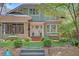 Charming two-story home with a welcoming front porch, brick pathway, mature trees, and manicured landscaping at 15 Northwood Ne Ave, Atlanta, GA 30309