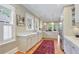 Well-lit kitchen featuring white cabinetry, hardwood floors, and stainless steel appliances at 15 Northwood Ne Ave, Atlanta, GA 30309
