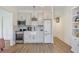 Compact kitchen featuring stainless appliances, farmhouse sink, elegant backsplash, and ample cabinet space at 15 Northwood Ne Ave, Atlanta, GA 30309