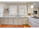 Bright kitchen with white cabinets, hardwood floors, stainless steel sink, and a view of the backyard at 15 Northwood Ne Ave, Atlanta, GA 30309