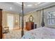 Relaxing main bedroom featuring a luxurious bed, a doorway to the bathroom, and bright windows at 15 Northwood Ne Ave, Atlanta, GA 30309