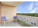 Cozy balcony with seating and a lovely view of the surrounding trees at 1501 Clairmont Rd # 1522, Decatur, GA 30033