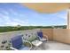 Balcony with two chairs and table offers a view of the treetops and city skyline at 1501 Clairmont Rd # 1522, Decatur, GA 30033
