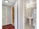 Hallway view of a bathroom featuring a pedestal sink, vanity, and tiled flooring at 1501 Clairmont Rd # 1522, Decatur, GA 30033