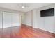 Bedroom featuring hardwood floors, a closet, and a wall mounted television at 1501 Clairmont Rd # 1522, Decatur, GA 30033