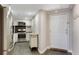 Open kitchen with stainless appliances flows into the entry with tiled floor and coat hooks at 1501 Clairmont Rd # 1522, Decatur, GA 30033