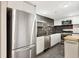 Bright kitchen with stainless refrigerator, sleek cabinets, black countertops, and open shelving at 1501 Clairmont Rd # 1522, Decatur, GA 30033