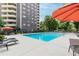 Condo community swimming pool features an expansive pool deck, lounge chairs, and umbrella seating at 1501 Clairmont Rd # 1522, Decatur, GA 30033