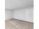Finished basement area with neutral carpet, crisp paint, and a drop ceiling adding to the room's clean aesthetic at 165 Lost Lake Trl, Villa Rica, GA 30180
