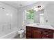 Bathroom featuring a combined shower and tub, modern light fixtures, and a dark vanity at 165 Lost Lake Trl, Villa Rica, GA 30180