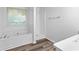 Bathroom featuring a bathtub, standing shower, and large window at 165 Lost Lake Trl, Villa Rica, GA 30180