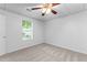 Finished basement bedroom with a large window, neutral carpet, and a striking ceiling fan adding modern appeal at 165 Lost Lake Trl, Villa Rica, GA 30180