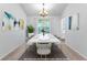 Staged dining room with modern art and seating for eight people at 165 Lost Lake Trl, Villa Rica, GA 30180
