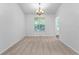 Open dining room featuring neutral walls, carpeted floor, and chandelier at 165 Lost Lake Trl, Villa Rica, GA 30180